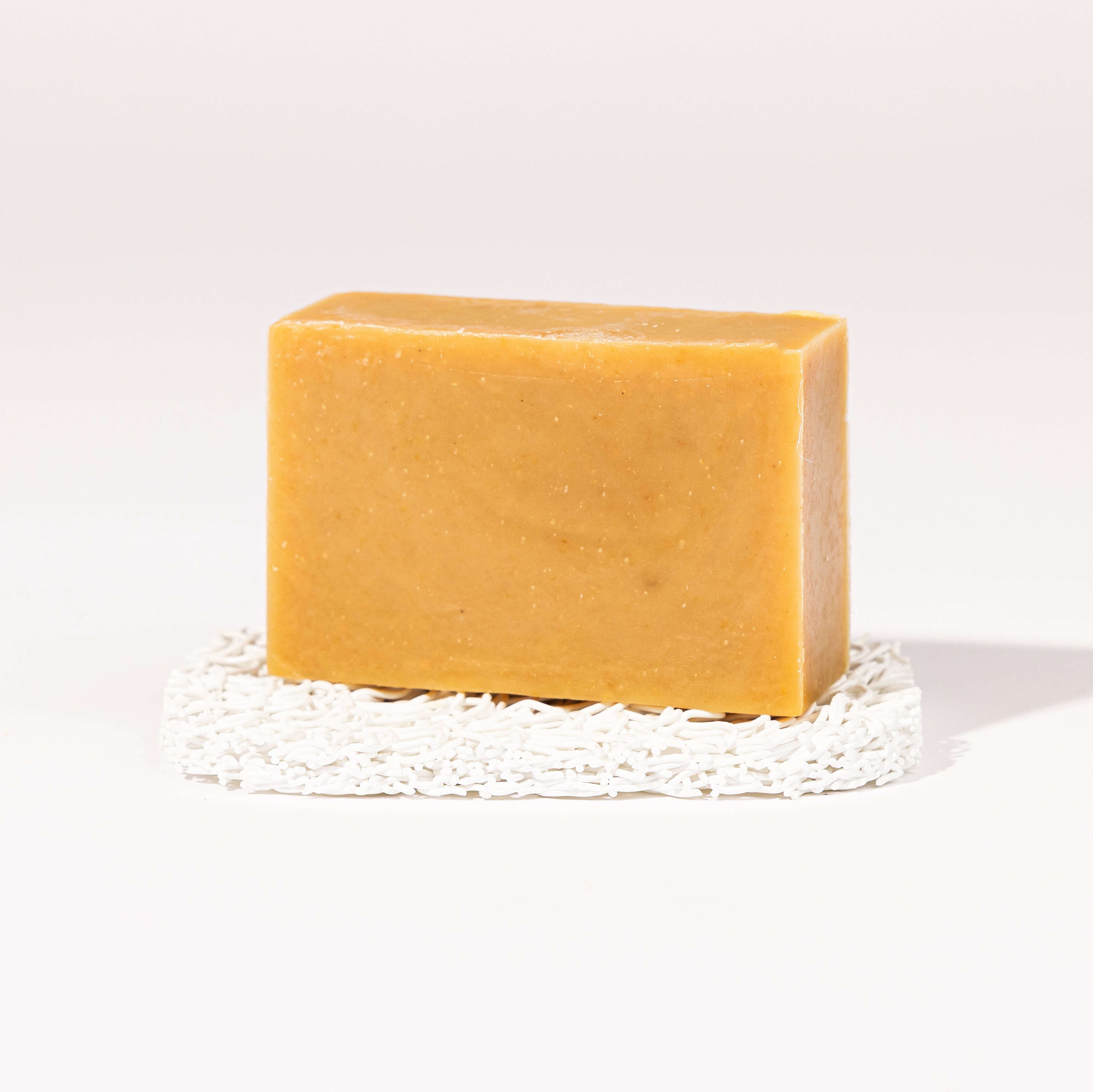 Madd House Hill Udder Maddness Chai Goat Milk Soap — unwrapped bar on soap lift, handmade hand cut all-natural goat milk soap, 4.5 oz