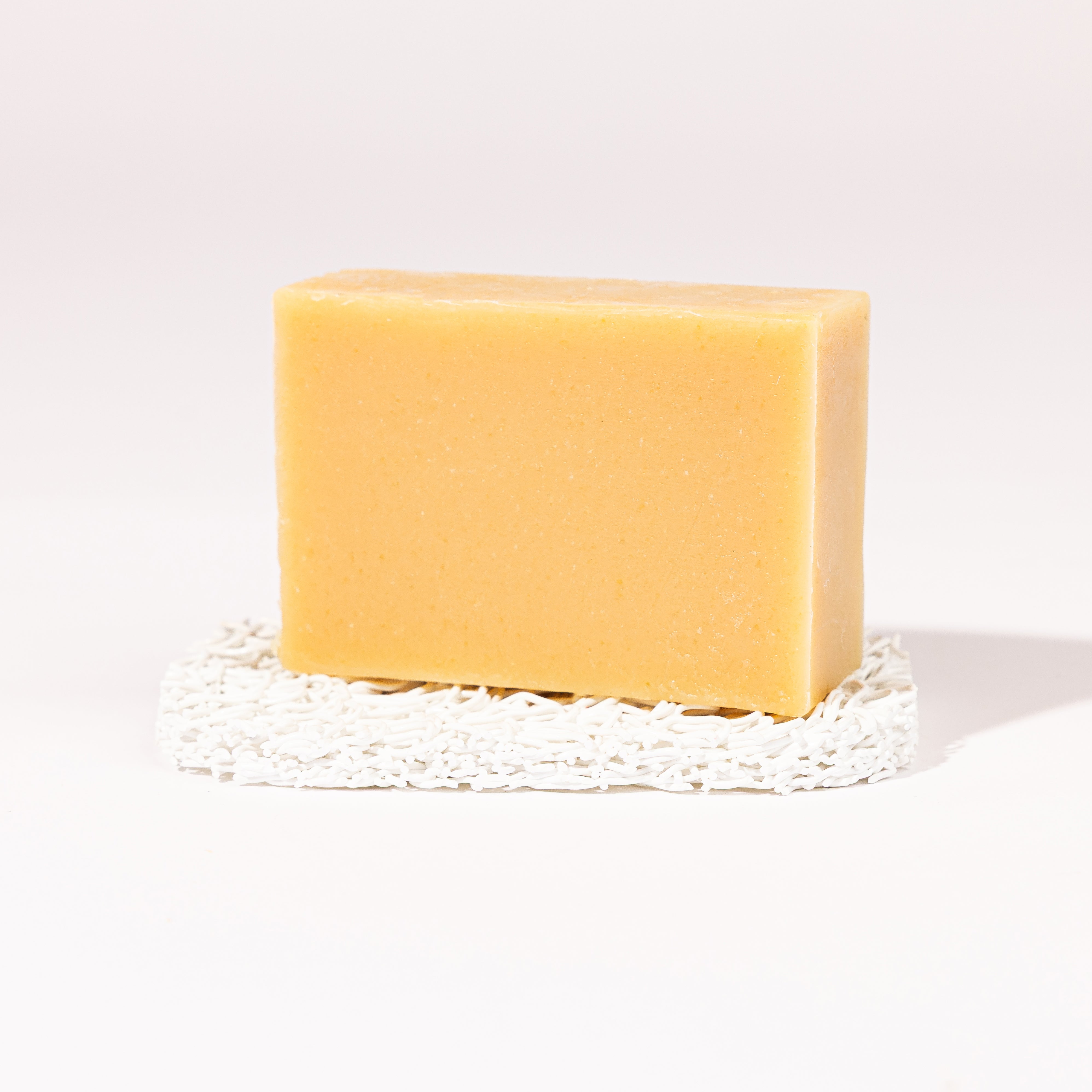 Madd House Hill Udder Maddness Eucalyptus Mint Tea Tree Goat Milk Soap — unwrapped bar on soap lift, handmade hand cut all-natural goat milk soap, 4.5 oz