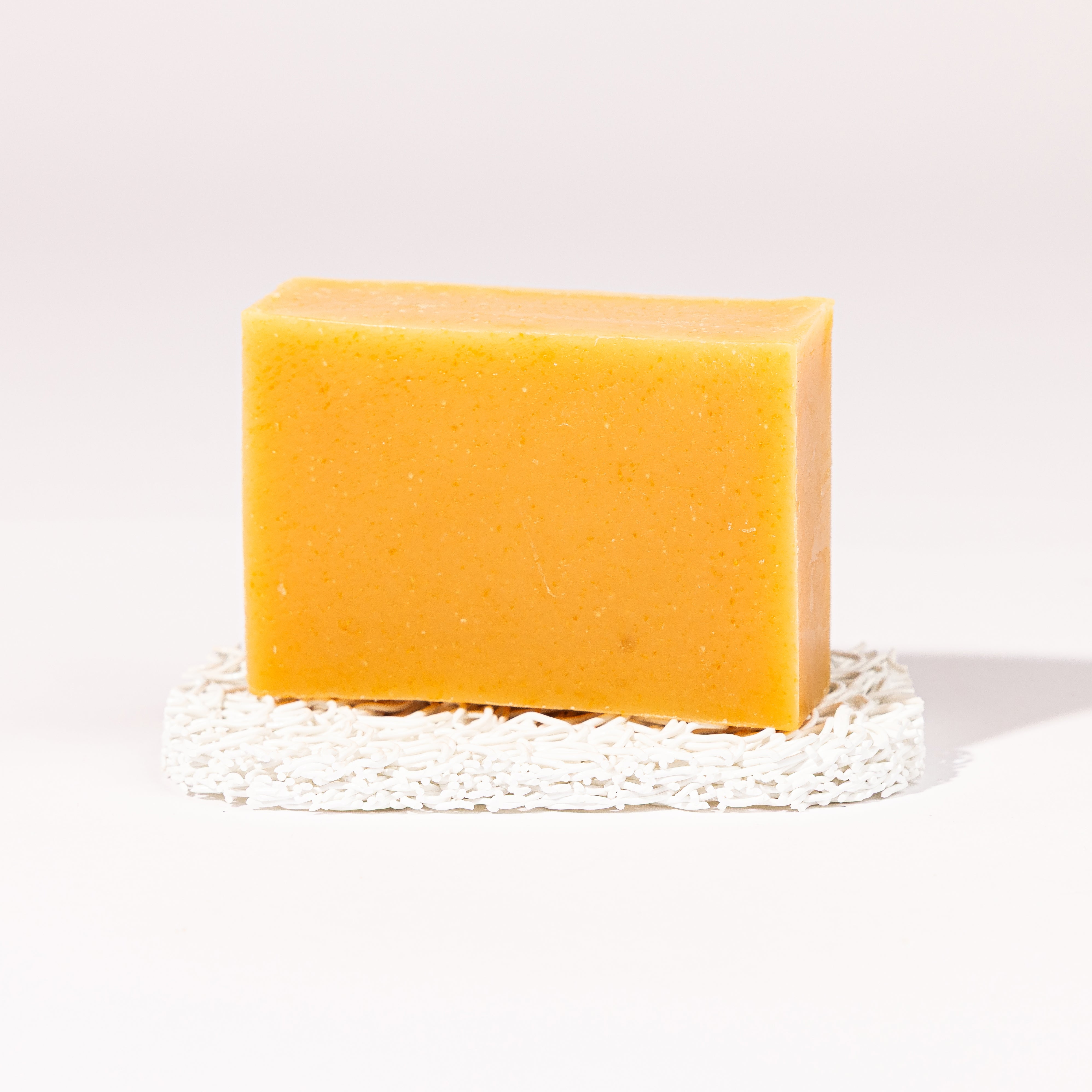 Madd House Hill Udder Maddness Insect Repellent Goat Milk Soap — unwrapped bar on soap lift, handmade hand cut all-natural DEET free goat milk soap, 4.5 oz