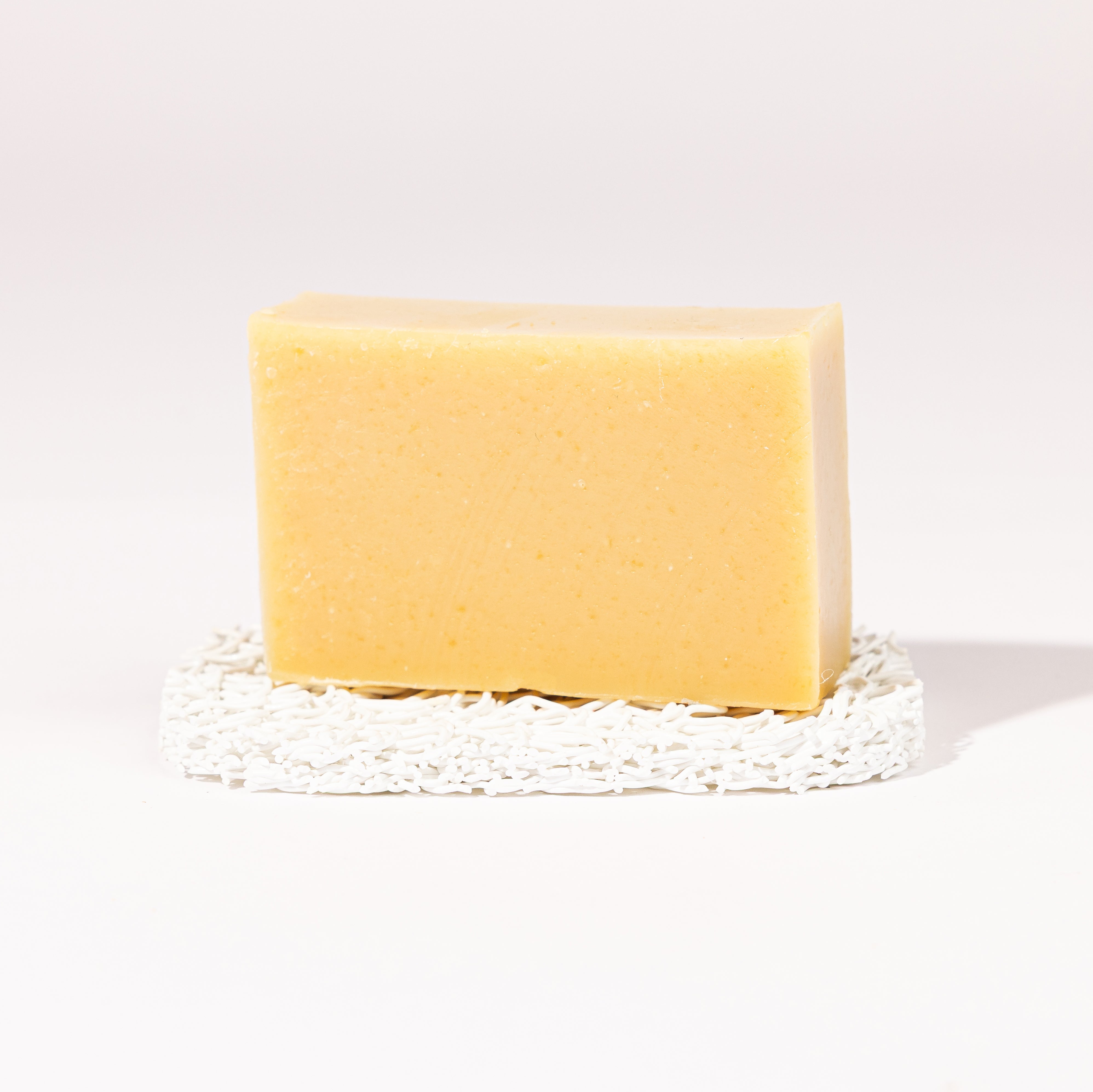 Madd House Hill Udder Maddness Lavender Patchouli Goat Milk Soap — unwrapped bar on soap lift, handmade hand cut all-natural goat milk soap, 4.5 oz