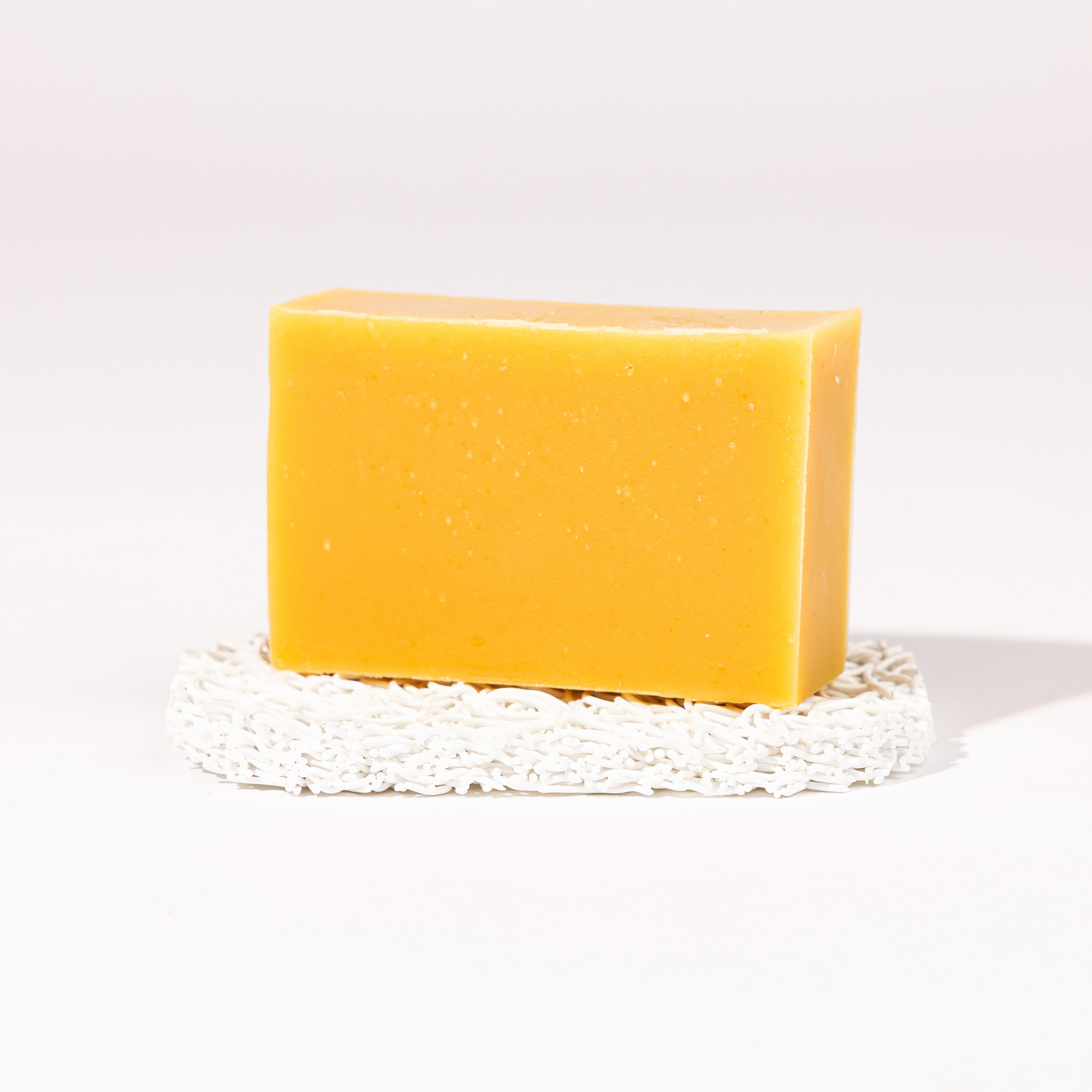 Madd House Hill Udder Maddness Lemon Mint Goat Milk Soap — unwrapped bar on soap lift, handmade hand cut all-natural goat milk soap, 4.5 oz