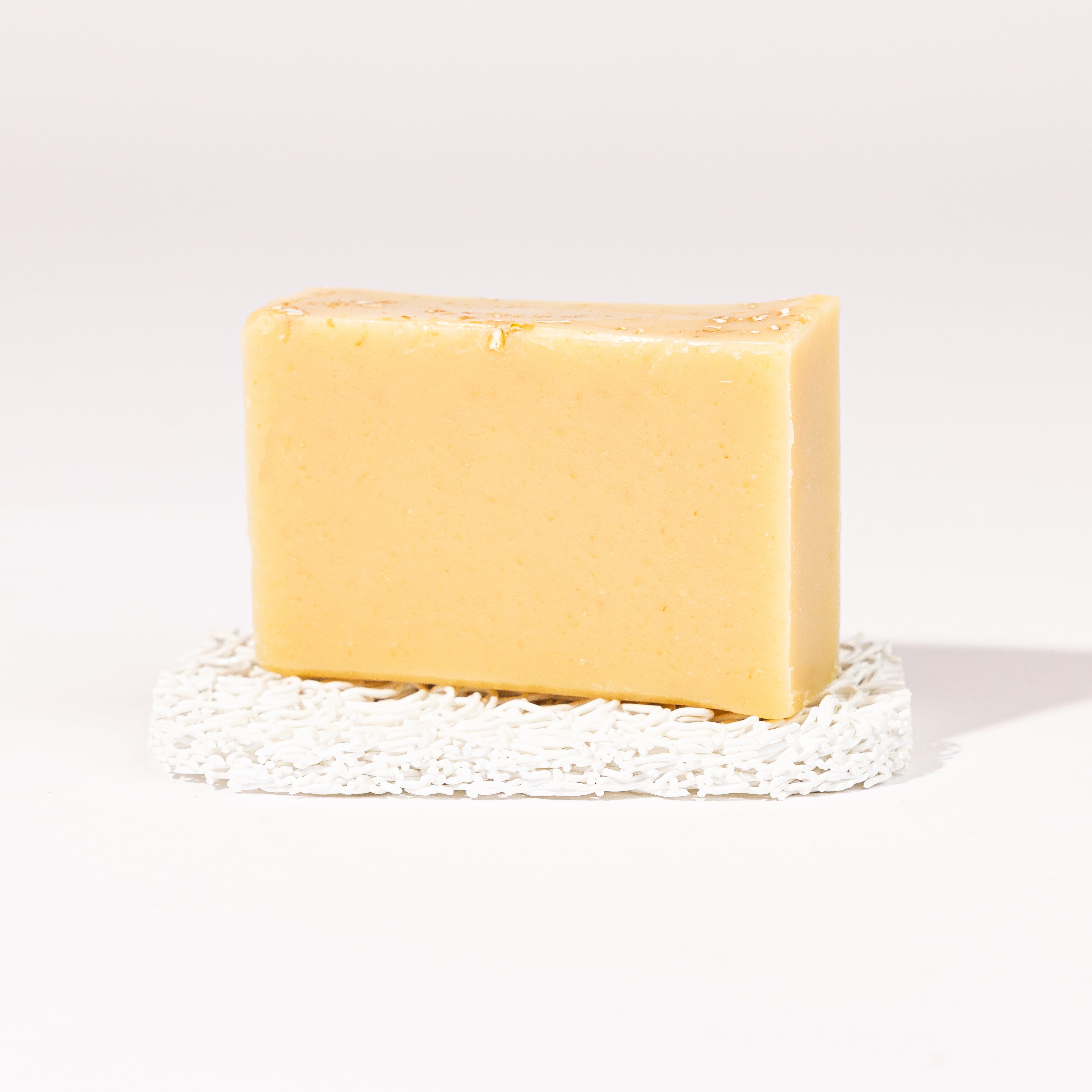 Madd House Hill Udder Maddness Oatmeal Lavender Goat Milk Soap — unwrapped bar on soap lift, handmade hand cut all-natural goat milk soap, 4.5 oz