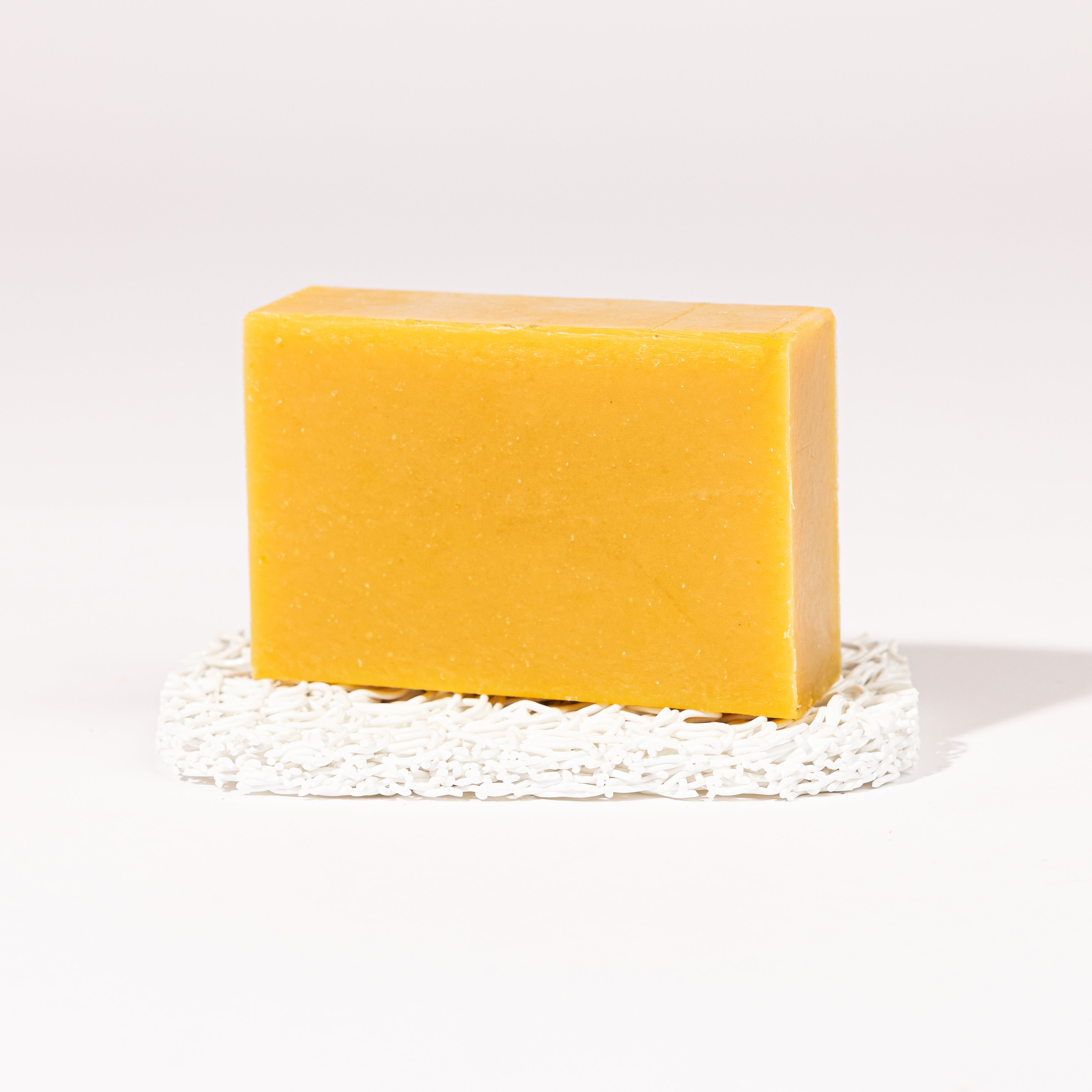 Madd House Hill Udder Maddness Overtime Pumice Goat Milk Soap — unwrapped bar on soap lift, handmade hand cut all-natural exfoliating goat milk soap, 4.5 oz