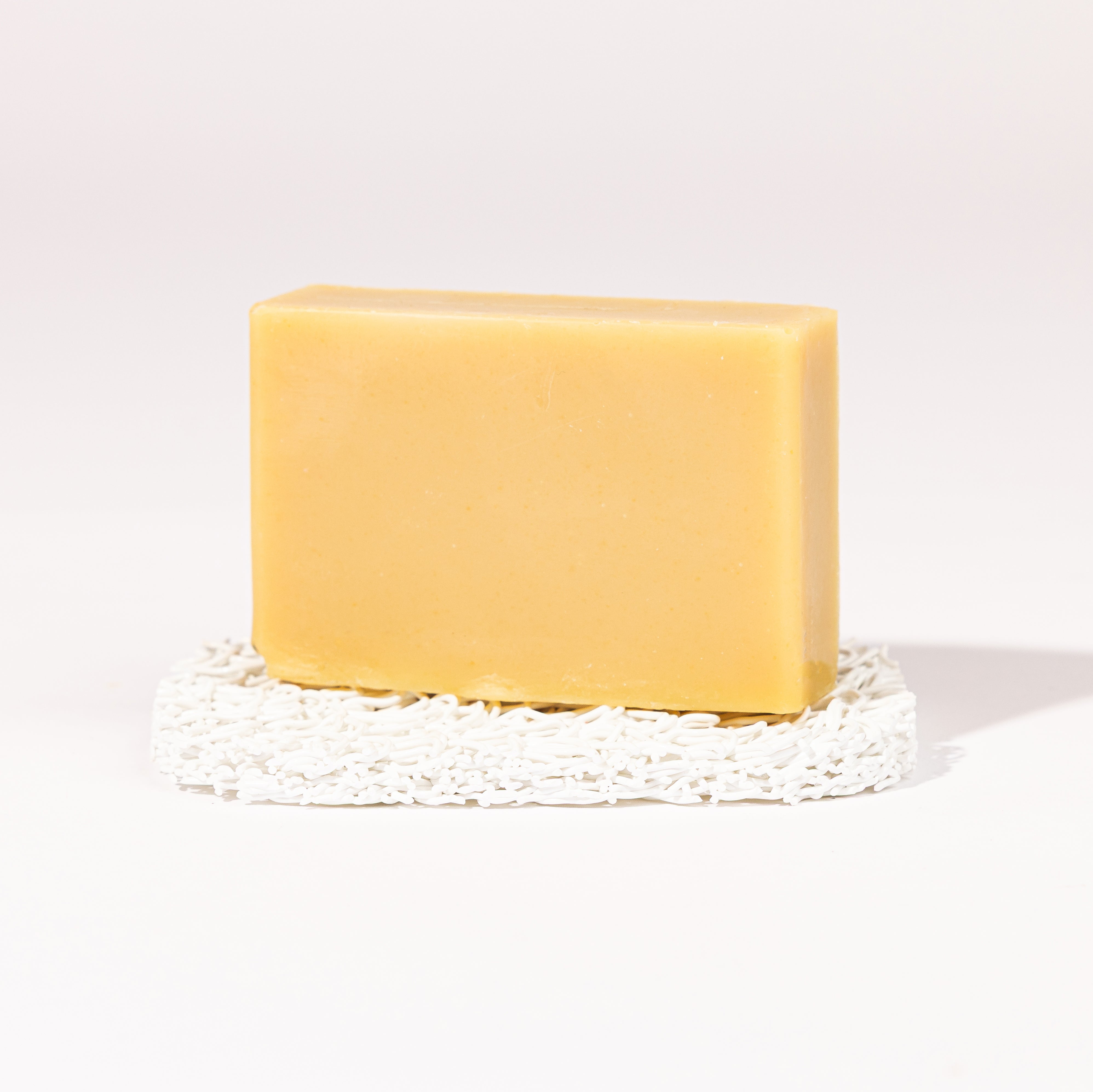Madd House Hill Udder Maddness Patchouli Goat Milk Soap — unwrapped bar on soap lift, handmade hand cut all-natural goat milk soap, 4.5 oz
