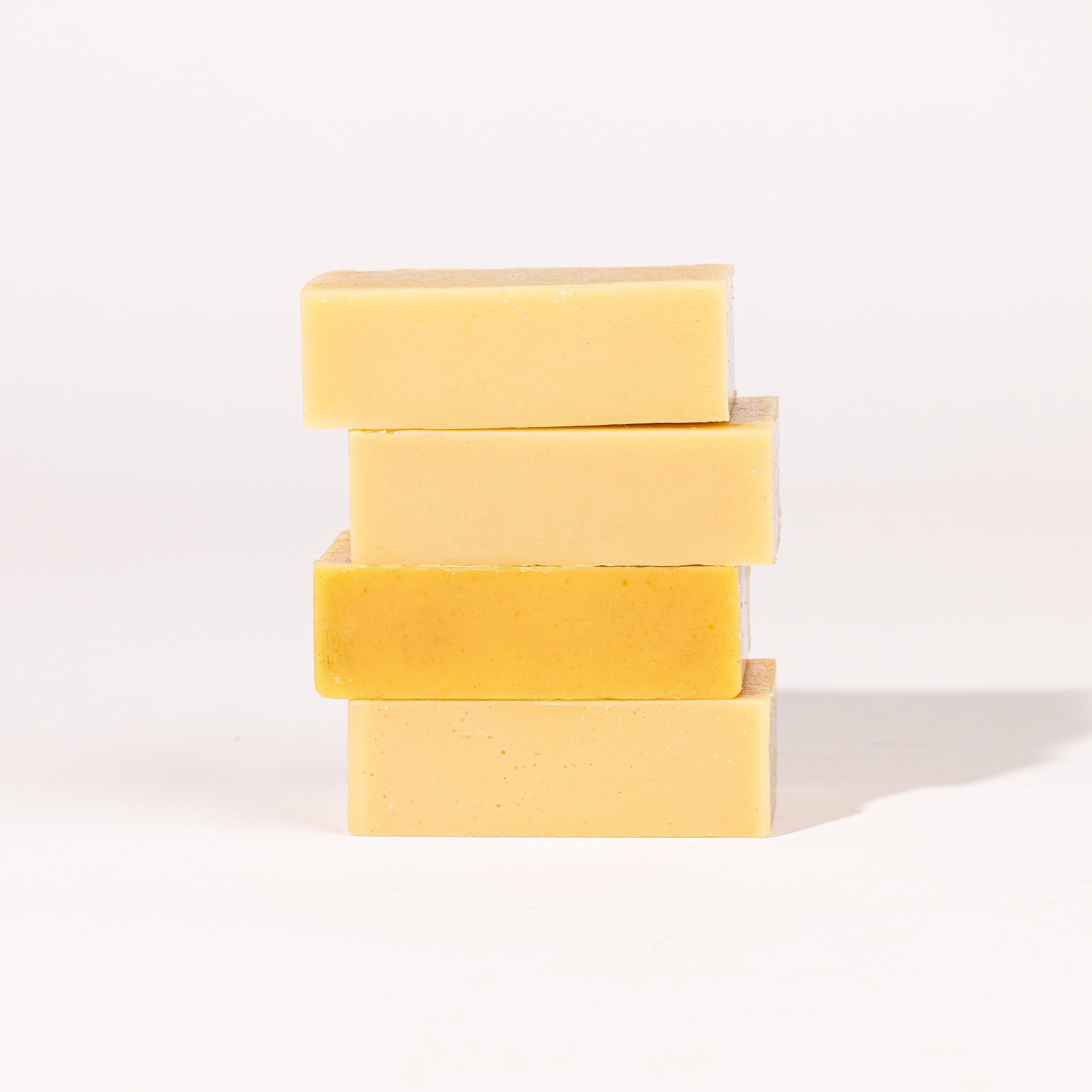 Madd House Hill Udder Maddness Goat Milk Soap Sack — four unwrapped handmade soap bars stacked showing rich creamy texture, all-natural goat milk soap, 4.5 oz each