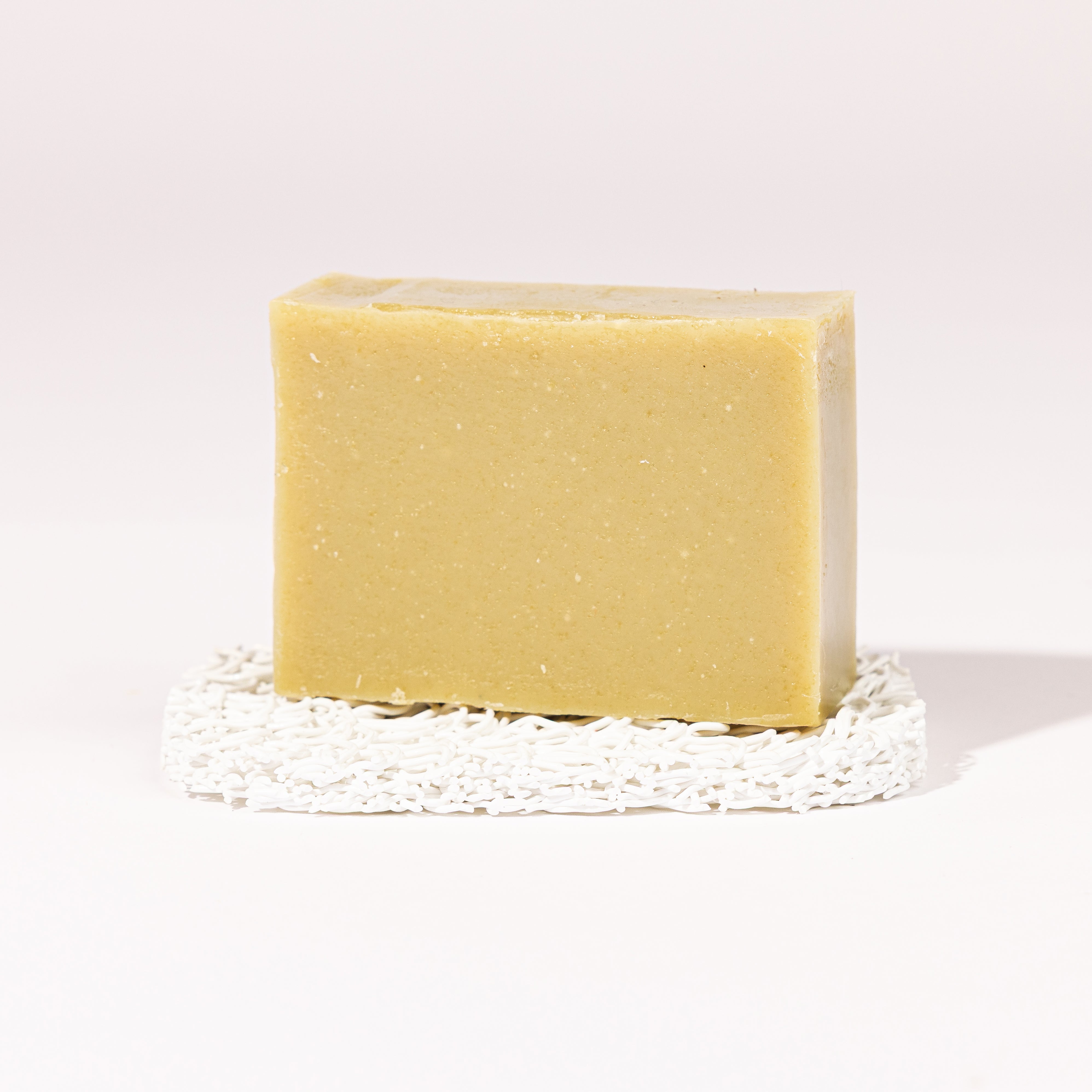 Madd House Hill Udder Maddness Tea Tree Lime Goat Milk Soap — unwrapped bar on soap lift, handmade hand cut all-natural goat milk soap, 4.5 oz